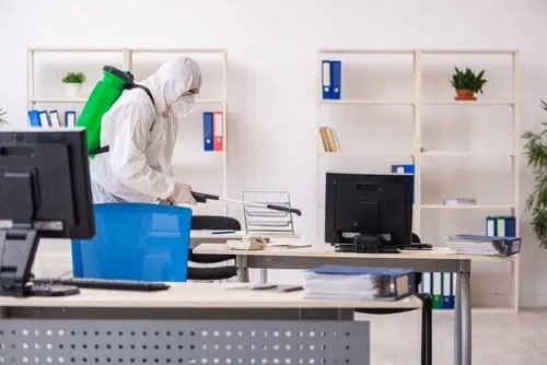 contractor disinfecting office.